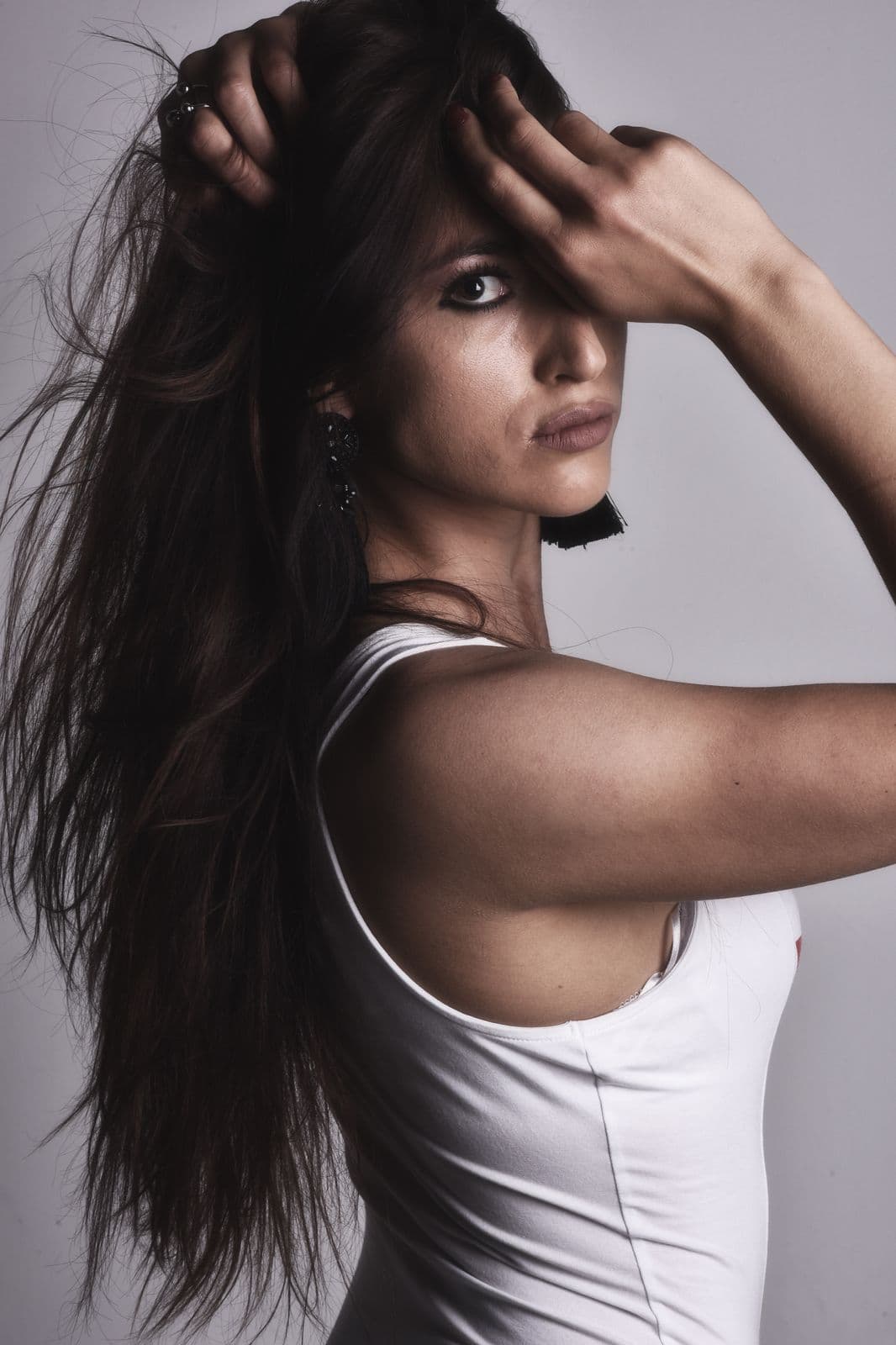 Woman with dark, softly styled hair