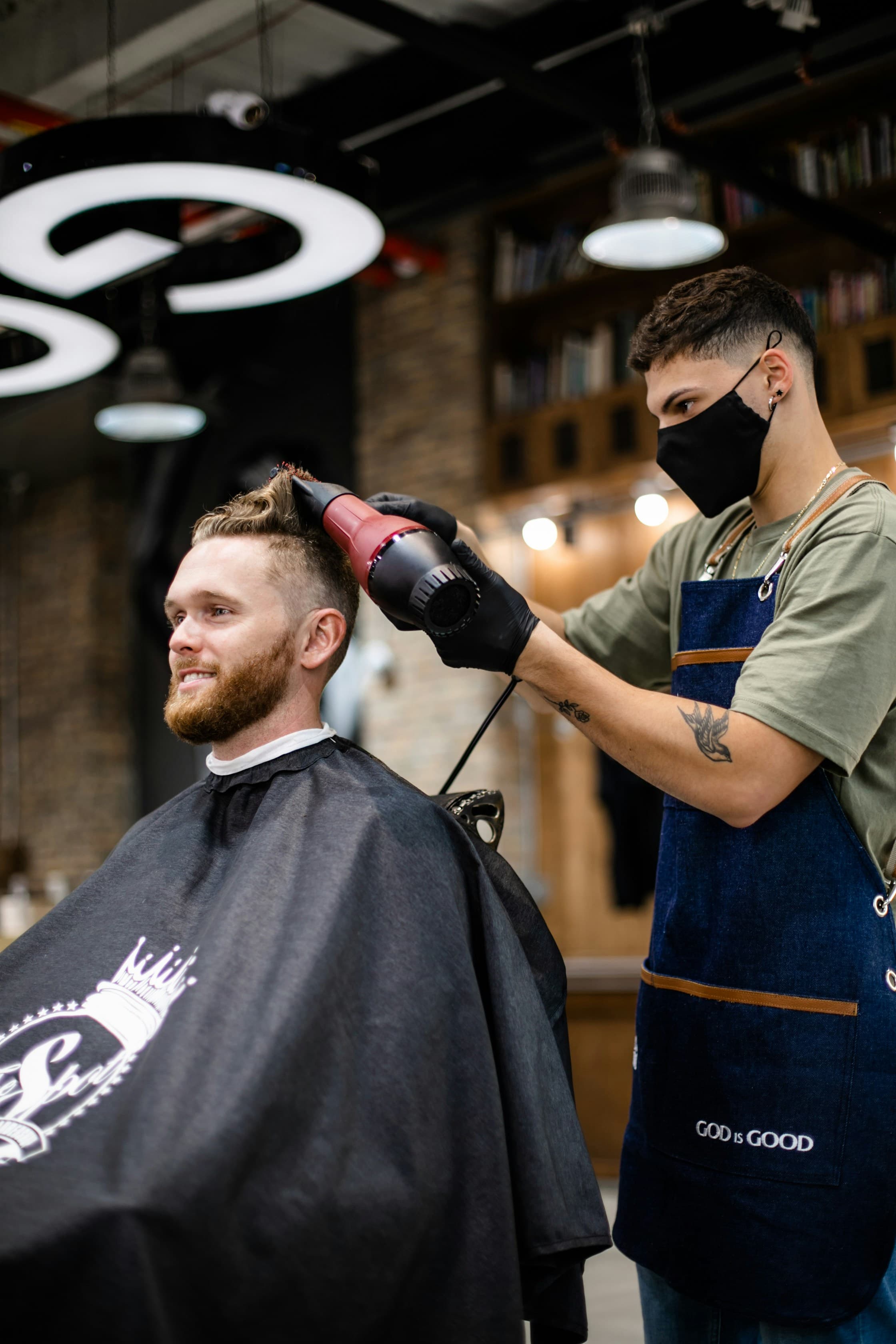 Stylist finishing a client's haircut in a neighbourhood salon