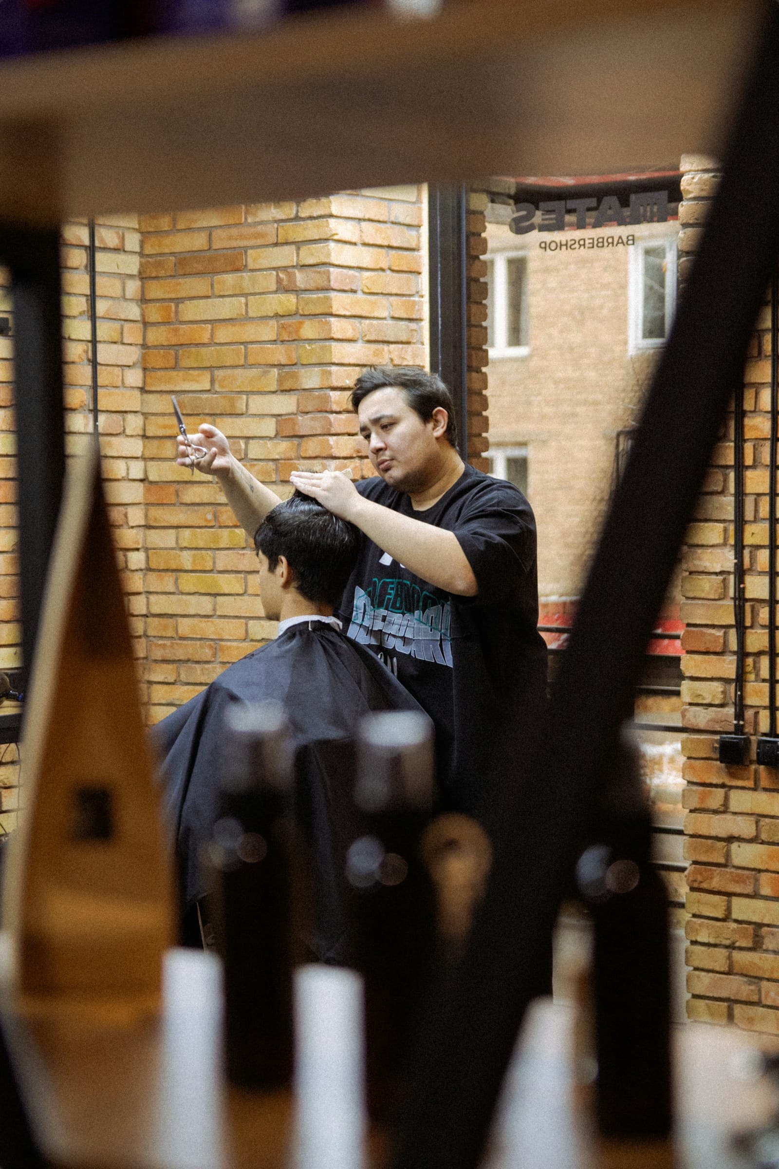 Barber shaping a client's haircut with scissors