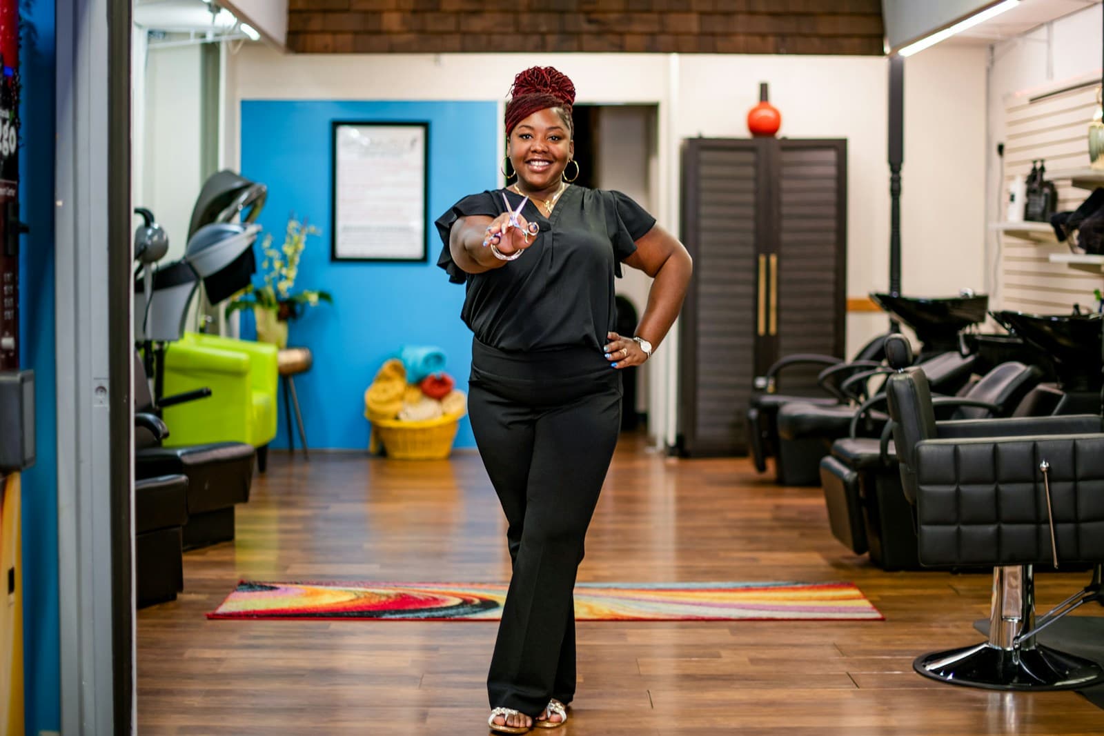 Hairstylist smiling inside a neighborhood salon